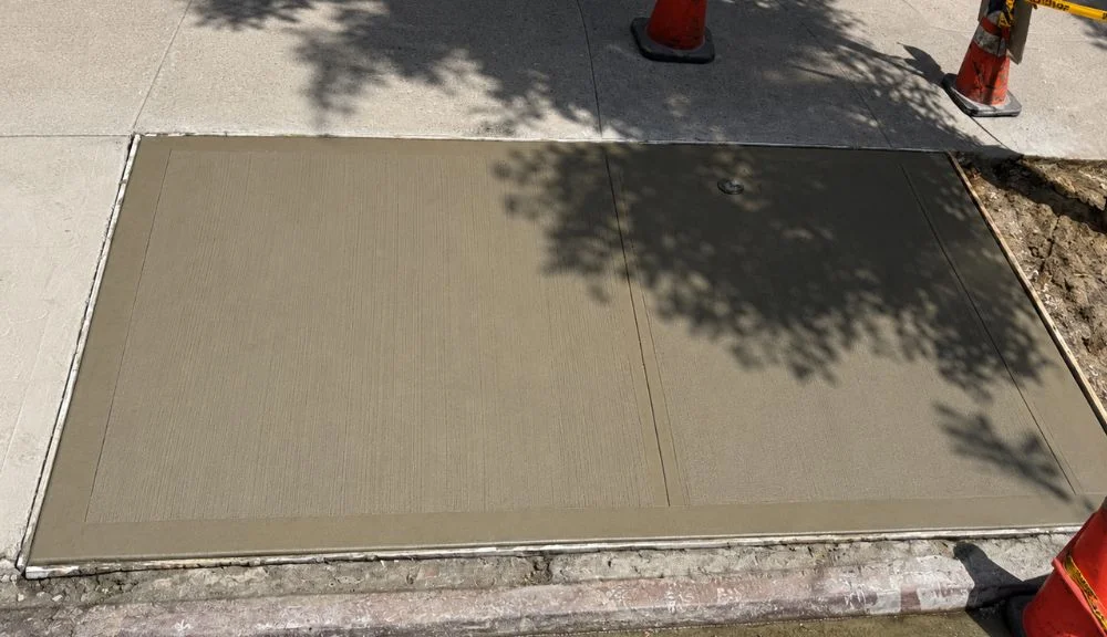 newly installed concrete sidewalk flags in east village Manhattan
